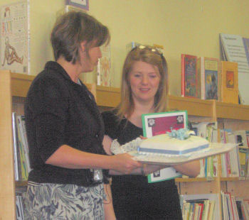 Mrs Burrows presents Miss Neary with her presents and a special cake